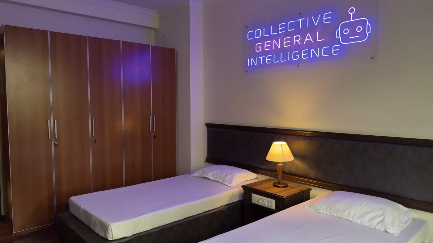 Shared twin room with a Collective General Intelligence neon sign